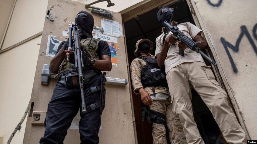 Bodyguards of former senators guard the doorway outside the court house during a hearing following the assassination of President Jovenel Moise, in Port-au-Prince, Haiti, July 12, 2021. 