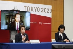 Seiko Hashimoto, front left, president of the Tokyo Organizing Committee of the Olympic and Paralympic Games (Tokyo 2020), speaks as Andrew Parsons, back left, president of the International Paralympic Committee, and Tamayo Marukawa, minister for…