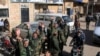 FILE - Fighters loyal to Syria's President Bashar al-Assad celebrate with residents of Nubul and al-Zahraa after breaking the siege of their towns in the northern Aleppo countryside, Syria, in this handout picture provided by SANA, Feb. 4, 2016.