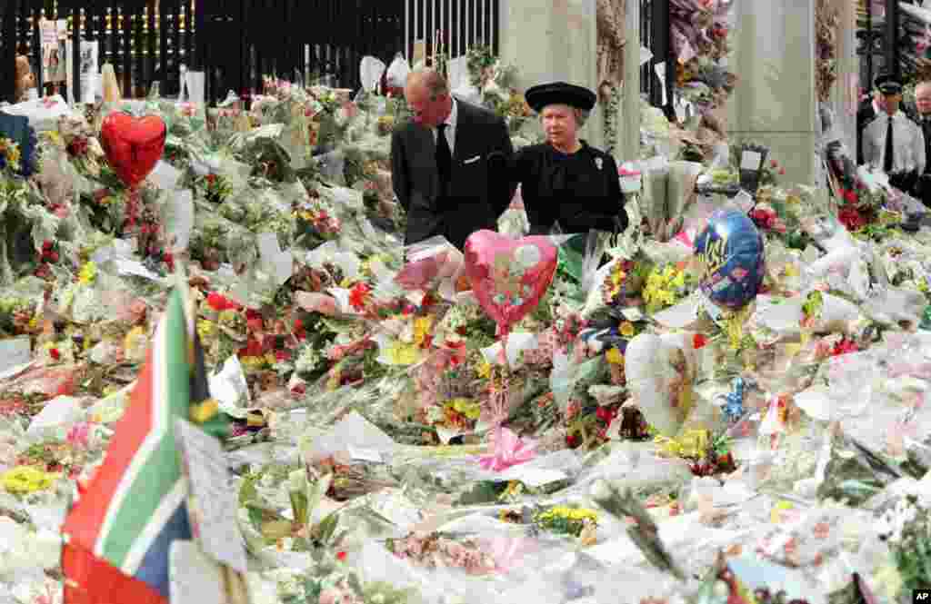 Queen Elizabeth II and Prince Philip view the floral tributes to Diana, Princess of Wales, at London's Buckingham Palace, Sept. 5, 1997.