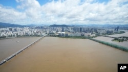 The Han River, swollen with floodwater, flows under bridges in Seoul, South Korea, Sept. 6, 2022.