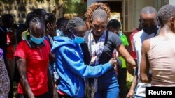 People react after viewing the body of Kelvin Kiptum at the Racecourse Mortuary, in the Rift Valley town of Eldoret, Kenya, Feb. 12, 2024.