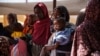 FILE - Women and babies wait at the Zamzam displacement camp, home to 400,000 people, in North Darfur, Sudan, in January 2024. (Medecins Sans Frontieres via Reuters)