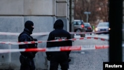 Members of the police stand guard following a shooting at one of Charles University's buildings in Prague, Czech Republic, Dec. 22, 2023.
