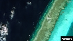 Philippine vessels are seen around Scarborough Shoal in the South China Sea, Feb. 22, 2024. (Maxar Technologies/Handout via Reuters)