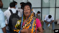 Kanchan Chowdary cries while looking for her husband, who was traveling in a train that derailed, in Balasore district, in the eastern Indian state of Orissa, June 4, 2023.