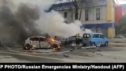 This photo taken from video released by the Russia Emergency Situations Ministry on Dec. 30, 2023, shows firefighters extinguishing flames after shelling in Belgorod, Russia, about 30 kilometers (19 miles) from the border with Ukraine.