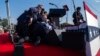 Republican presidential candidate former President Donald Trump is surrounded by U.S. Secret Service agents at a campaign rally, July 13, 2024, in Butler, Pennsylvania. 