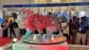 FILE - Visitors stand next to a "Make In India" logo during a three-day semiconductor event in Bengaluru, India, April 30, 2022. Japan and India signed an agreement July 20, 2023, to jointly develop semiconductors