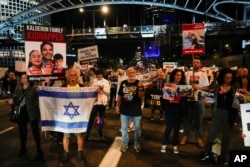 Families and friends of about 240 hostages held by Hamas in Gaza call for Israeli Prime Minister Benjamin Netanyahu to bring them home, during a demonstration in Tel Aviv, Israel, Nov. 21, 2023.