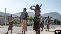 FILE - Members of the Afar militia stand in a checkpoint at the entrance of the town of Abala, 480 kilometers of Semera, Ethiopia, June 08, 2022.