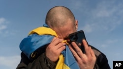 FILE - A newly freed Ukrainian prisoner of war cries while calling relatives after a prisoner exchange on Jan. 31, 2024. U.N. investigators on Sept. 23, 2024, accused Russia of torturing and using sexual violence against Ukrainian citizens and prisoners of war.
