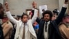 Tennessee state lawmakers Justin Pearson and Justin Jones raise their hands after being expelled from their seats in Nashville, Tennessee, April 6, 2023.
