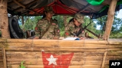 FILE - This photo taken on Dec. 9, 2023, shows female members of the Mandalay People's Defense Forces (MDY-PDF) standing guard at their base camp in the forest near Namhsan Township in Myanmar's northern Shan State.