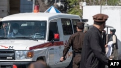 An ambulance carries victims from near the site of a suicide attack in Kabul on March 27, 2023. 