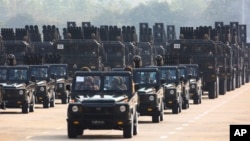 FILE - Military vehicles are seen during a parade in Naypyitaw, Myanmar, March 27, 2023.