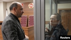 FILE — Radio Free Europe/Radio Liberty journalist Alsu Kurmasheva, accused of violating Russia's law on foreign agents, talks to her lawyer during a court hearing in Kazan, Russia, Oct. 23, 2023. 