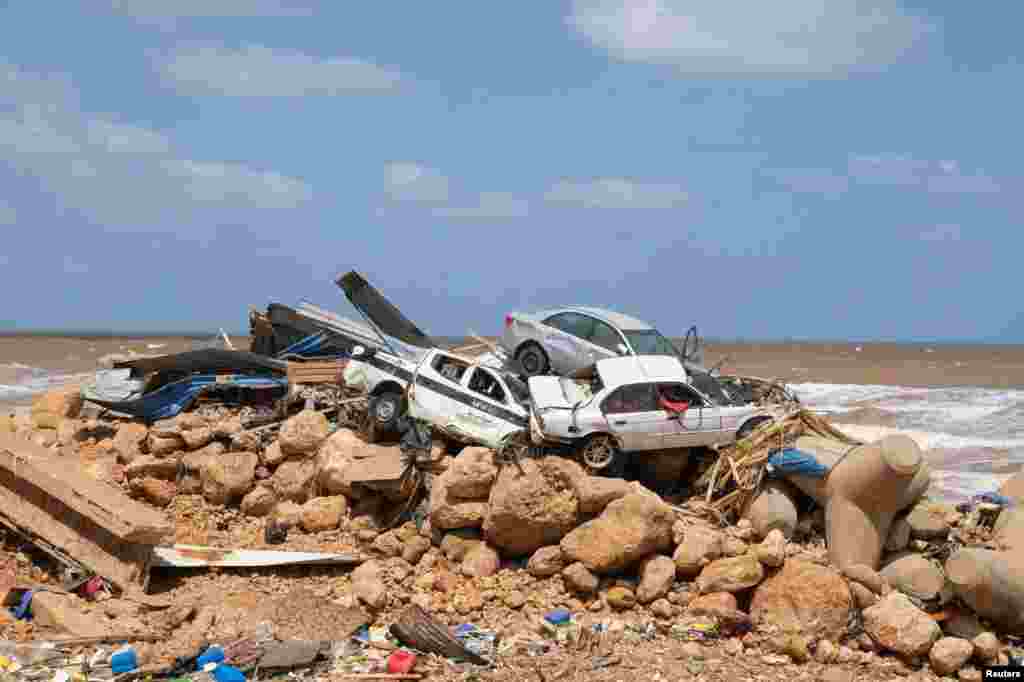 Damaged cars sit in a pile in Derna after a powerful storm and heavy rainfall hit Libya, Sept. 12, 2023.