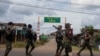 FILE - Volunteer members of Karenni insurgent forces walk in Moe Bye in Kayah State, Myanmar Nov. 12, 2023. 