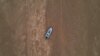 FILE - A boat is seen stranded on the dry riverbed of the Pahang river in Chenor, Malaysia's Pahang state, Aug. 10, 2023.