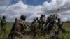 FILE - Ukrainian servicemen prepare to fire at Russian positions from a U.S.-supplied M777 howitzer in Kharkiv region, Ukraine, July 14, 2022. U.S. officials say the Pentagon will announce soon it is sending up to $500 million in military aid to Ukraine.