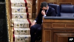 FILE - Spain's Prime Minister Pedro Sanchez listens to a speech by Vox party leader Santiago Abascal during a parliamentary session in Madrid, Spain, Oct. 21, 2020.