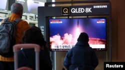 People at a railway station in Seoul, South Korea, watch a TV broadcast of a news report about North Korea firing a ballistic missile into the sea off its east coast, March 16, 2023. 