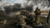 Ukrainian servicemen fire a 105mm Howitzer towards Russian positions, near the city of Bakhmut, March 4, 2023. 