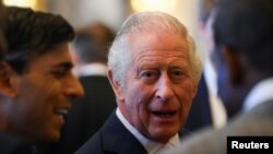 Britain's King Charles looks on next to the British Prime Minister Rishi Sunak as they attend a Realm Governors General and Prime Ministers Lunch, ahead of the coronation of Britain's King Charles III, at Buckingham Palace in London, Britain, May 5, 2023. 