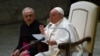 Pope Francis, assisted by Prefect of the Pontifical House, Monsignor Leonardo Sapienza (L), addresses attendees during the weekly general audience, Feb. 15, 2023 at Paul-VI hall in The Vatican.
