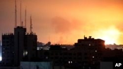 Explosions caused by Israeli airstrikes are visible in the northern Gaza Strip, Oct. 27, 2023.