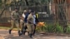 Police arrest a protester during the march to Parliament protest in Kampala, Uganda, July 23, 2024. (Halima Athumani/VOA)