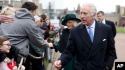 Britain's King Charles III and Queen Camilla greet people after attending the Easter Matins Service at St. George's Chapel, Windsor Castle, England, March 31, 2024. 