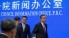 Chinese Foreign Minister Wang Yi, right, leaves after a press conference at the State Council Information Office in Beijing, Sept. 26, 2023. 