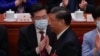 FILE - Chinese President Xi Jinping walks by then newly elected Chinese Foreign Minister Qin Gang during the closing ceremony for China's National People's Congress at the Great Hall of the People in Beijing, March 13, 2023.