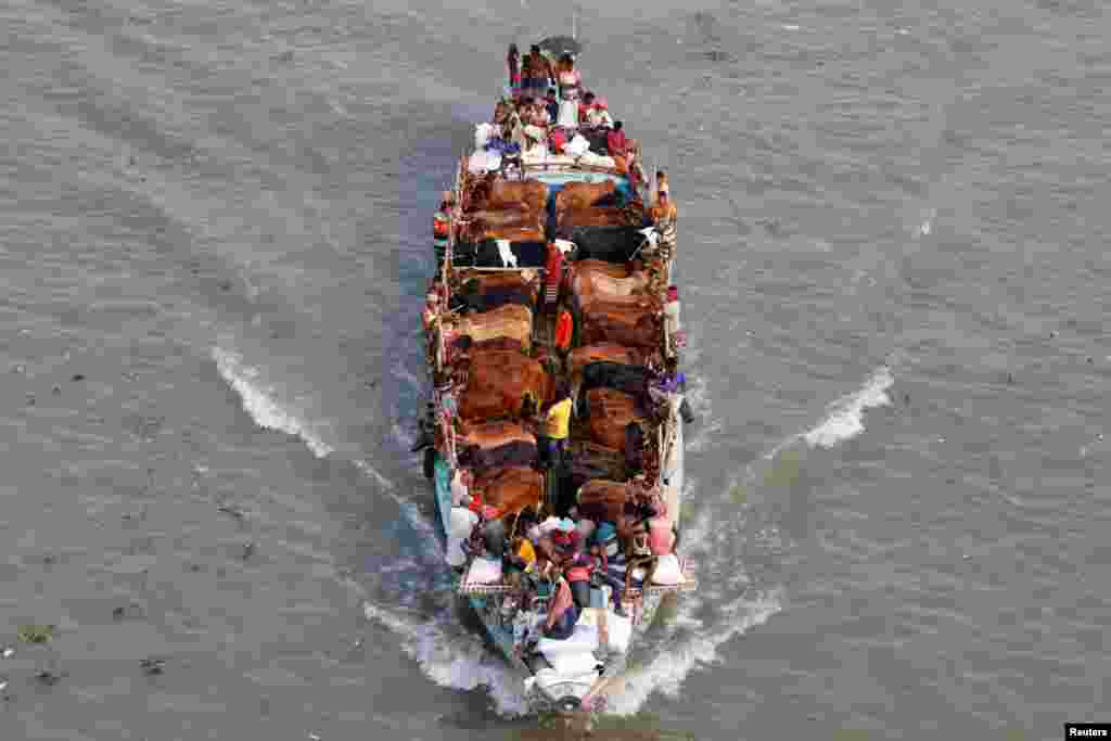 Cattle traders bring their livestock to a market on a trawler ahead of Eid-al-Adha, in Dhaka, Bangladesh.