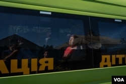 Lydia sits in a bus waiting to be evacuated along with other Kupiansk residents as the battles get closer on Aug. 19, 2023. (Yan Boechat/VOA)