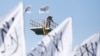 FILE - A Taliban fighter is seen at the Taliban flag-raising ceremony in Kabul, Afghanistan, March 31, 2022. 