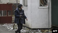 FILE - AFP journalist Arman Soldin walks in a village after a shelling on March 3, 2022, in Ukraine. Arman was killed by a rocket strike as he reported with AFP colleagues from Ukrainian positions in Chasiv Yar on May 9, 2023. 