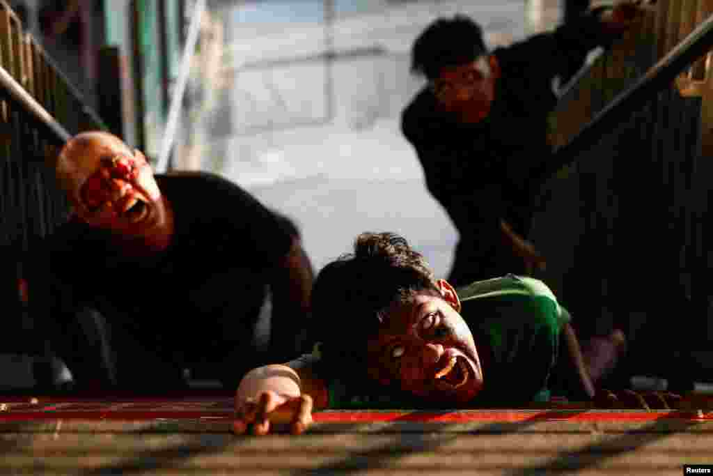 People perform as zombies during the 'Train to Apocalypse: No Way Out' event, held to entertain commuters and attract people to use Light Rail Transit (LRT) train, in Jakarta, Indonesia.