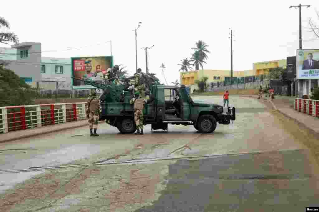 Soldiers of the Republican Guard stand on their armed pickup truck on a street in Libreville, Gabon. A group of senior military officers said they had seized power just minutes after the Central African state's election body announced that President Ali Bongo had won a third term.