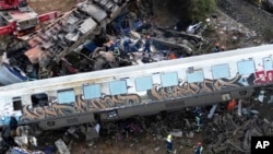 FILE - Firefighters and rescuers operate after a collision in Tempe near Larissa city, Greece, March 1, 2023. 