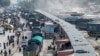 FILE - Afghan cargo trucks loaded with coal arrive from Pakistan at the Afghanistan-Pakistan Torkham border post in Nangarhar province, Feb. 2, 2023. The crossing is set to reopen Sept. 15, 2023, following a security closure.
