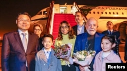 Brazil's President Luiz Inacio Lula da Silva and first lady Rosangela "Janja" da Silva are welcomed to Shanghai, China, by Vice Minister of Foreign Affairs Xie Feng, April 13, 2023. (Ricardo Stuckert/Handout via Reuters)