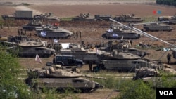 Cientos de tanques, vehículos blindados, camiones cisterna se pueden ver desde la carretera en la frontera sur de Israel. [Foto: Alejandro Ernesto, VOA]. 