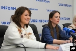 FILE - Center for Civil Liberties head of the board Oleksandra Matviychuk, right, and executive director Oleksandra Romantsova attend the press conference in Kyiv, Ukraine, Oct. 8, 2022.