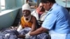 FILE — A nurse treats a flood victim in Queen Elizabeth Central hospital in Blantyre, Malawi, March 16, 2023. In Malawi, thousands of unemployed nurses are urging the government to help them find work.