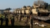 FILE - U.S. soldiers prepare to unload Bradley Infantry Fighting Vehicles from rail cars as they arrive at the Pabrade railway station near Vilnius, Lithuania, Oct. 21, 2019. 