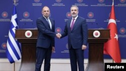 Turkish Foreign Minister Hakan Fidan, right, shakes hands with his Greek counterpart, Giorgos Gerapetritis, during their press conference in Ankara, Turkey, Sept. 5, 2023.