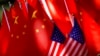 FILE - The flags of China and the U.S. are displayed on top of a trishaw in Beijing, Sept. 16, 2018. 